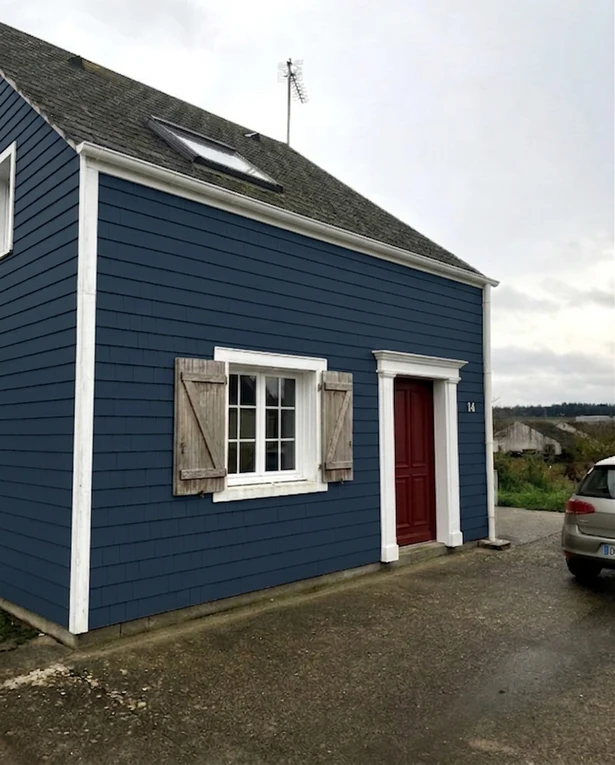 After — facade in Naval Navy (SW 6244) with Pure White + Antique Red Door on the trim and front door (Cape Cod)