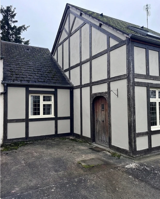 After - facade in Sandtex Mid Grey (RAL 7044) with Classic Cream on the window frames (Mock Tudor)