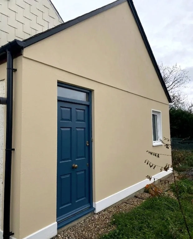 After — facade in Natural Stone (RAL 1019) with Stiffkey Blue on the door (Heritage)
