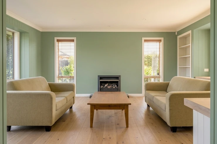 After - facade in Sage Green (BM Saybrook Sage HC-114 equivalent) with Warm White on the trim, ceiling and built-in shelving (Modern Farmhouse)
