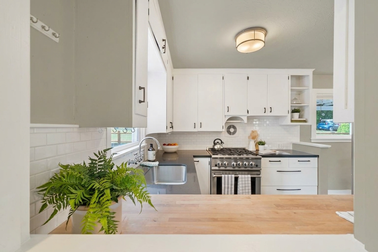 After - facade in Wimborne White (F&B No.239) with Light Greige on the lower cabinets, kitchen island, larder unit (Shaker British Country)